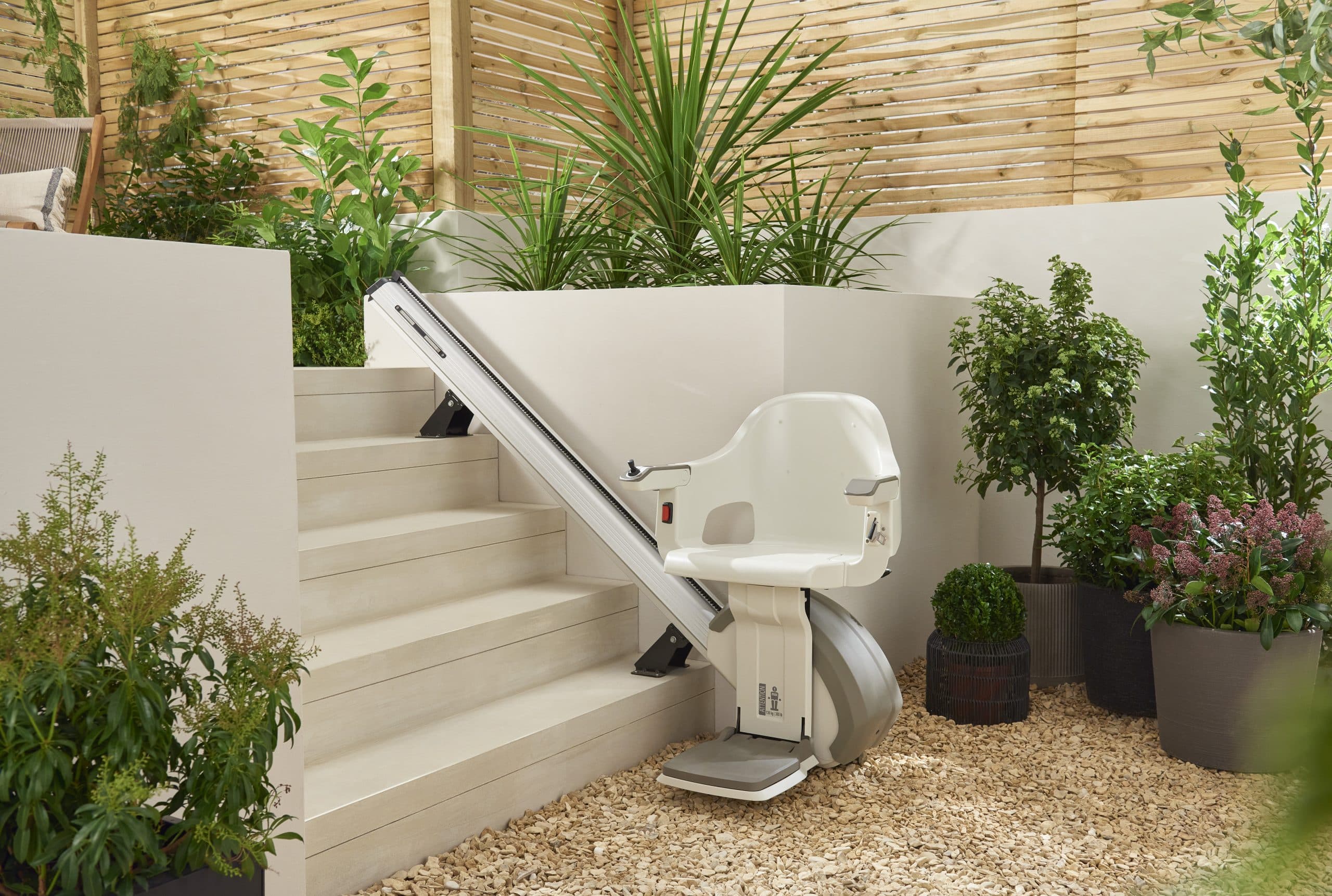 Image of a HomeGlide Outdoor stairlift at the bottom of patio stairs