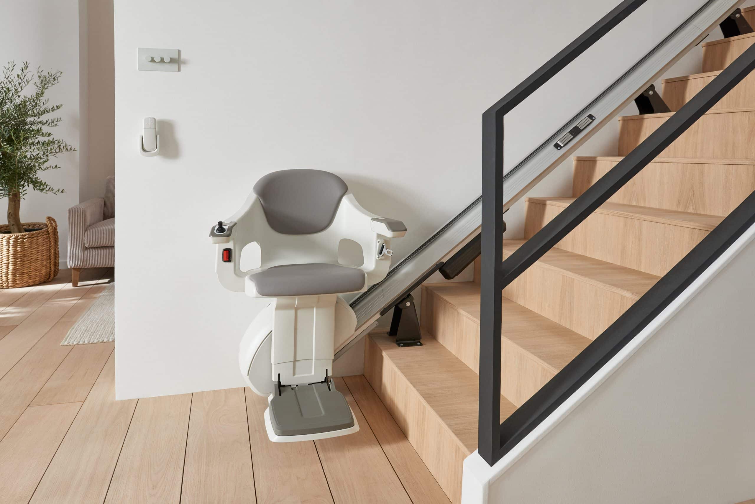 Image of a HomeGlide stairlift at the bottom of the stairs.